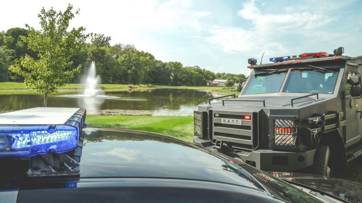 Emergency Response Vehicles Parked by a Pond